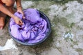 Woman wash hands dirty clothes in the basin black for cleansing Royalty Free Stock Photo