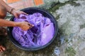 Woman wash hands dirty clothes in the basin black for cleansing Royalty Free Stock Photo