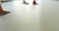 A woman washes the floor with a mop.