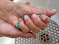 Woman washes her hands, arthritis, old age