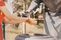 Woman washes her hands on the street in a spring fountain in the form of a sculpture of a water carrier Royalty Free Stock Photo