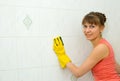 The woman washes a tile