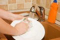 The woman washes ware on kitchen Royalty Free Stock Photo