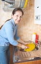 Woman washes ware on kitchen Royalty Free Stock Photo