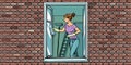 Woman washes a window, home cleaning