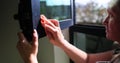 Woman washes windows diligently maintaining spotless home