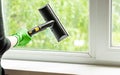 woman washes the windows of a house with a steam generator. To clean up the house in the spring. House cleaning.