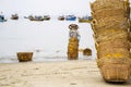 Woman washing baskets for anchovies used for fish sauce on February 7, 2012 in Mui Ne, Vietnam. Royalty Free Stock Photo