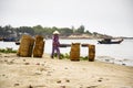 Woman washing baskets on fish sauce production, Mui Ne, Vietnam Royalty Free Stock Photo