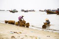 Woman washing baskets on fish sauce production, Mui Ne, Vietnam Royalty Free Stock Photo