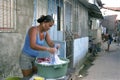 Woman is washing clothes in Brazil slum in Recife