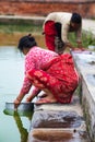 Woman washing clothes in lake