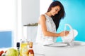 Woman washing the dishes in the kitchen. Royalty Free Stock Photo