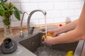 Woman washing dishes in the kitchen. Close up of woman hand Royalty Free Stock Photo