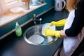 Woman washing dishes in the kitchen with sponge. Royalty Free Stock Photo
