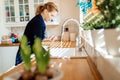 Woman washing dishes in kitchen