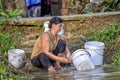 Woman washing dishes in Mekong river Royalty Free Stock Photo