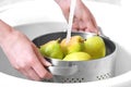 Woman washing fresh ripe in kitchen sink, closeup Royalty Free Stock Photo