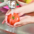 Woman washing fresh vegetables in kitchen Royalty Free Stock Photo