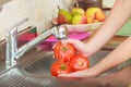 Woman washing fresh vegetables in kitchen Royalty Free Stock Photo