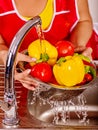 Woman washing fruit at kitchen. Royalty Free Stock Photo