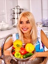 Woman washing fruit at kitchen. Royalty Free Stock Photo
