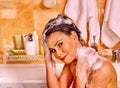 Woman washing hair in bubble bath Royalty Free Stock Photo