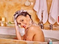 Woman washing hair in bubble bath Royalty Free Stock Photo