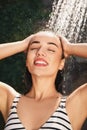 Woman washing hair in outdoor shower on summer day, closeup Royalty Free Stock Photo