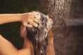 Woman washing hair in outdoor shower on summer day, closeup Royalty Free Stock Photo