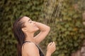 Woman washing hair in outdoor shower on summer day Royalty Free Stock Photo