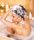 Woman washing hair by shampoo . Royalty Free Stock Photo