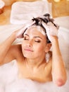 Woman washing hair by shampoo . Royalty Free Stock Photo