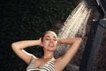 Woman washing hair in outdoor shower on summer day Royalty Free Stock Photo