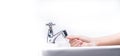 Woman washing hand with soap foam and tap water in bathroom. Hand clean under faucet on sink for personal hygiene to prevent flu Royalty Free Stock Photo