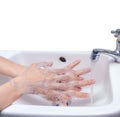 Woman washing hand with soap foam and tap water in bathroom. Hand clean under faucet on sink for personal hygiene to prevent flu Royalty Free Stock Photo