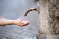 Woman washing hands in a city fountain in Rome, Italy Royalty Free Stock Photo