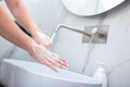 Woman washing hands with foam soap. Hygiene, preventing coronavirus