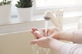 Woman washing hands on the kitchen sink at home. Concept of hygiene during the coronavirus epidemic. Corona Virus Prevention. Royalty Free Stock Photo