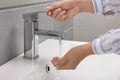 Woman washing hands with water from tap in bathroom, closeup Royalty Free Stock Photo