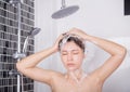 Woman washing head and hair in the rain shower by shampoo Royalty Free Stock Photo