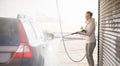 Woman washing her car in a manual carwash