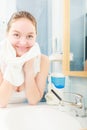 Woman washing her face with clean water in bathroom Royalty Free Stock Photo