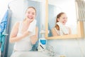 Woman washing her face with clean water in bathroom Royalty Free Stock Photo