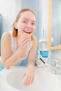 Woman washing her face with clean water in bathroom Royalty Free Stock Photo