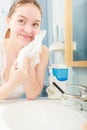 Woman washing her face with clean water in bathroom Royalty Free Stock Photo