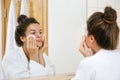 Woman is washing her face with lotion and cotton pads Royalty Free Stock Photo