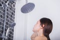 Woman is washing her face by rain shower Royalty Free Stock Photo