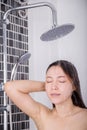 Woman is washing her hair and face by rain shower Royalty Free Stock Photo