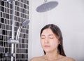 Woman is washing her hair and face by rain shower Royalty Free Stock Photo